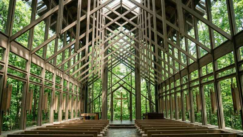 Interior view of the glass walls and wooden beams at Thorncrown Chapel in the Ozark woods