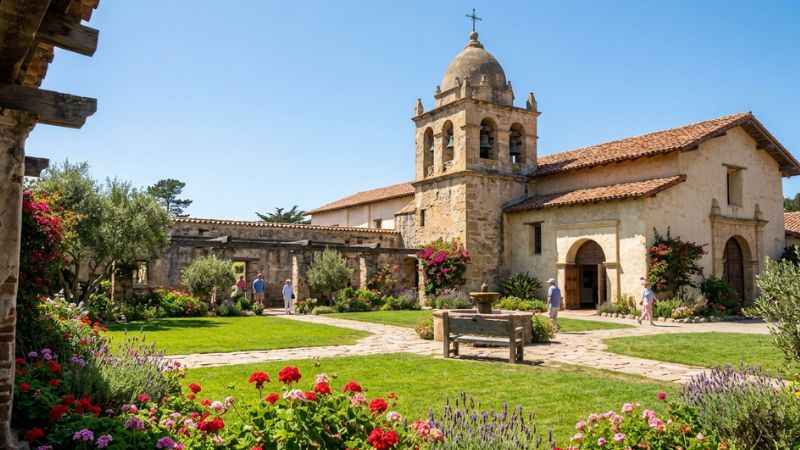 Stone church building and garden courtyard at the historic Carmel Mission Basilica.