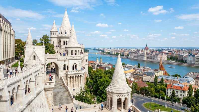 Tourists walking along the scenic stone lookout towers of Fisherman’s Bastion in Budapest.