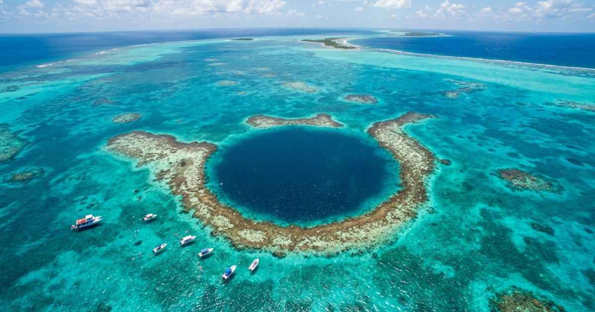 Aerial view of the Great Blue Hole and coral reef in Belize.