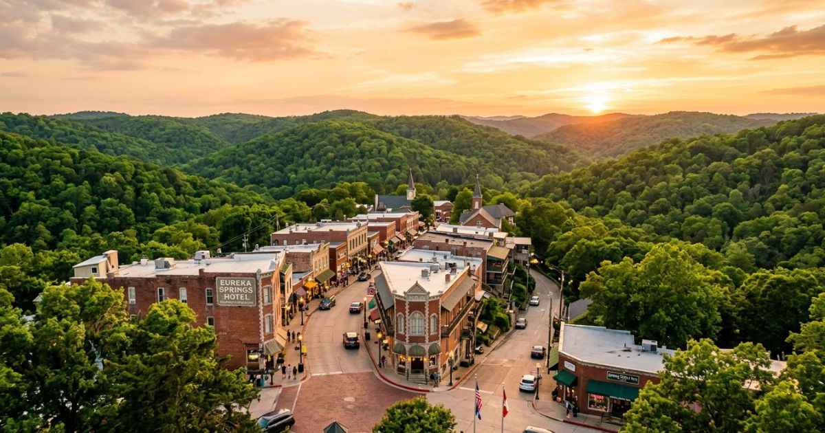 Historic Victorian buildings and winding streets in downtown Eureka Springs during sunset