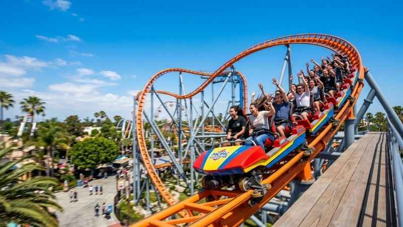 Roller coaster cars moving fast on a track at Knott's Berry Farm in Buena Park near Anaheim.