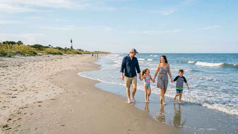 Visitors walking along the quiet sand at North Beach on Tybee Island.