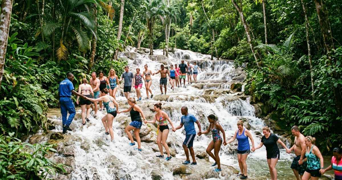 Visitors climbing the cascading tiers of Dunn’s River Falls in Ocho Rios, Jamaica.