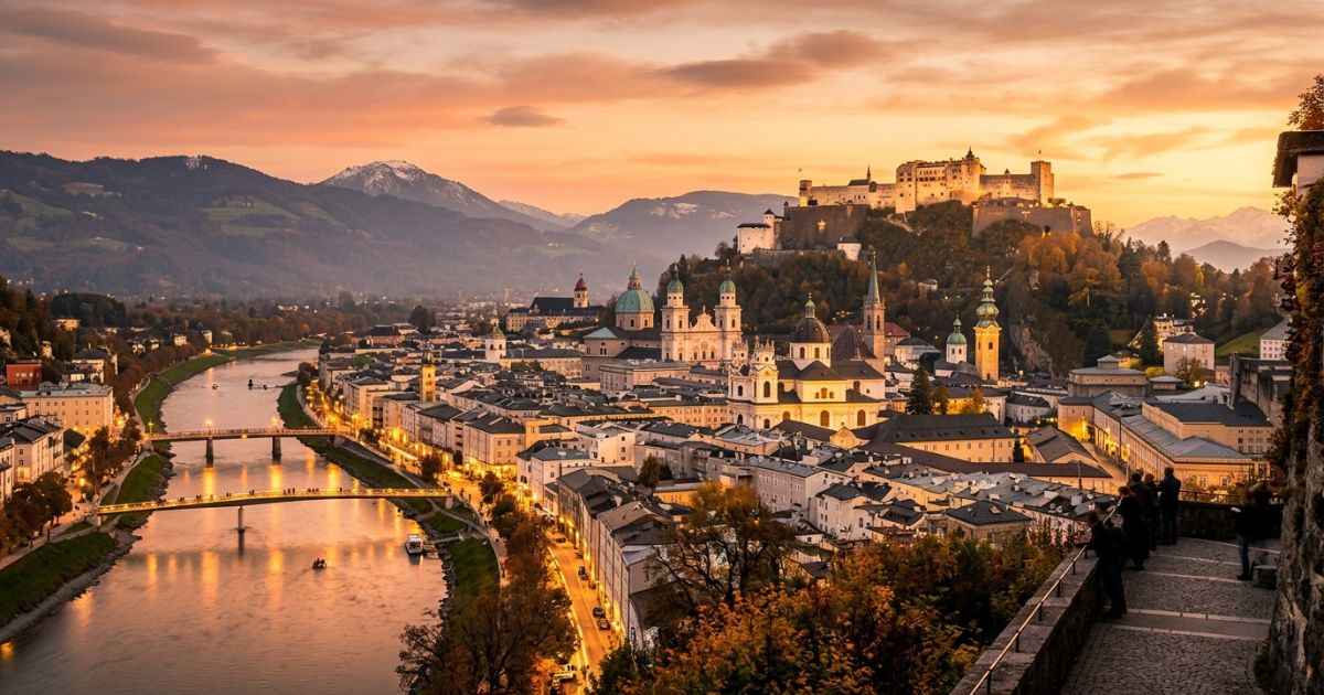 Hohensalzburg Fortress overlooking the historic Old Town of Salzburg at sunset.
