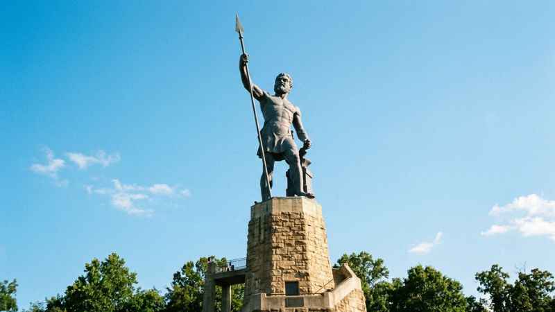The massive iron Vulcan statue standing on a stone pedestal at Vulcan Park in Birmingham, Alabama.