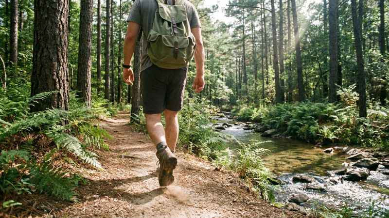 A hiker walking on the David Boren trail network in Beavers Bend State Park.