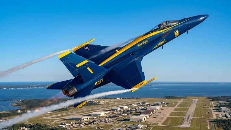 A Blue Angels flight demonstration aircraft performing a maneuver over NAS Pensacola.