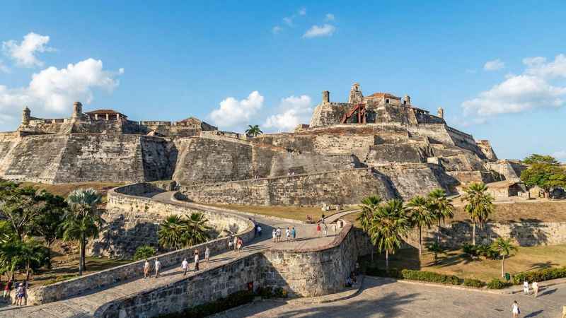 Historic stone ramparts of the Castillo San Felipe de Barajas fortress under a clear sky in Cartagena.