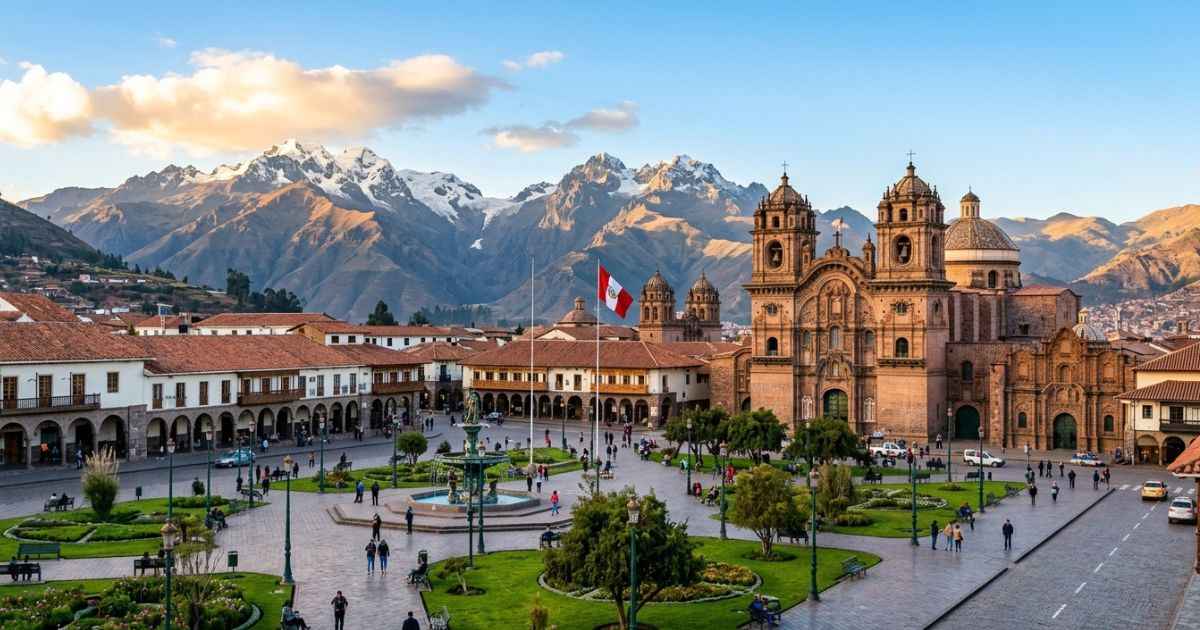 Vibrant golden hour view of Cusco's historic Plaza de Armas with colonial red-tiled roofs and Andean mountains.