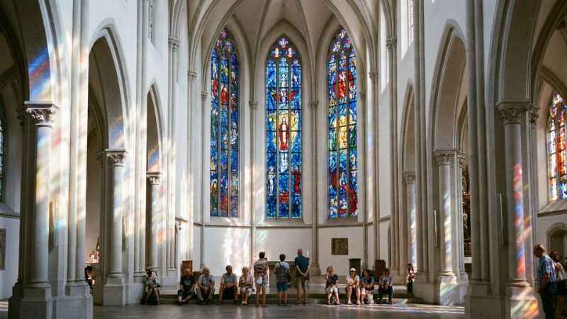 Marc Chagall stained glass windows glowing inside the Fraumünster church in Zurich.