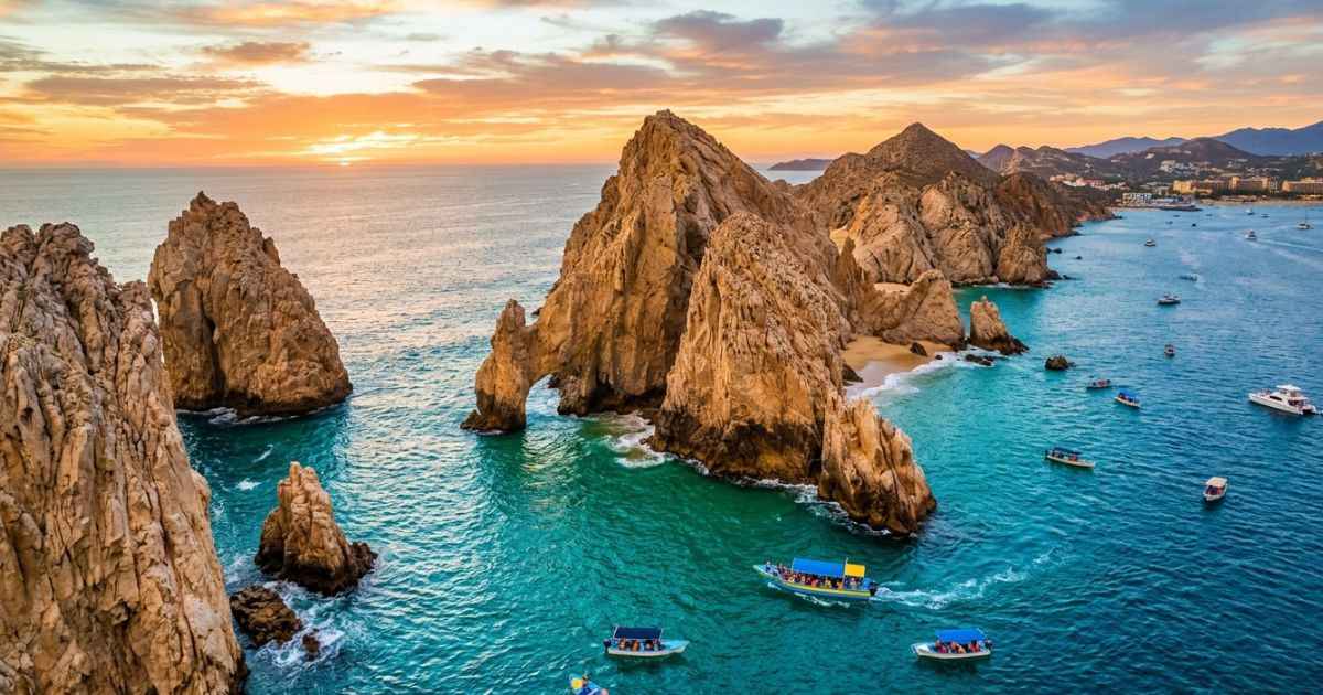 Aerial view of El Arco rock formation and turquoise water in Cabo San Lucas.